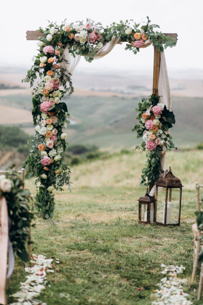 beautiful archway decorated with floral composition outdoors